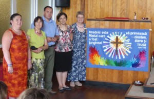 Andrei and Eugenia with the Banner Group and banner in Romanian (Blessed is the Lamb who was slain to receive glory and honour and praise)